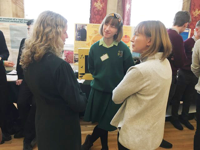 Anna from St Angela's College discusses her project with her mother Angela and CSDEU Director Orla Mc Breen