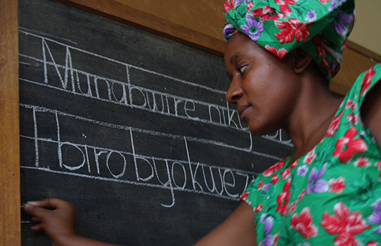 A teacher writing on a blackboard