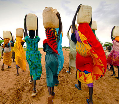 Landing- Woman carrying water collected from taps