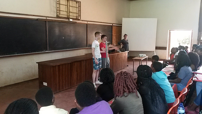 Diarmuid Curtin (right) and Jack O'Connor (left) presenting their award-winning ergonomic seed planter to students at Lilongwe University of Agriculture and Natural Resources, Malawi. Credit: Gorta Self Help Africa