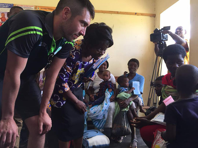 Ireland cricketer Andrew Balbirnie meets with mothers and children at the Rutope Clinic, Bindura, Zimbabwe